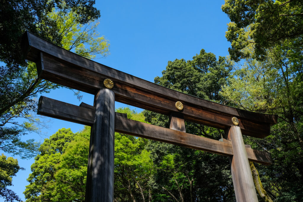 A large wooden shrine gate (torii), on the path towards the Meiji Jingu.