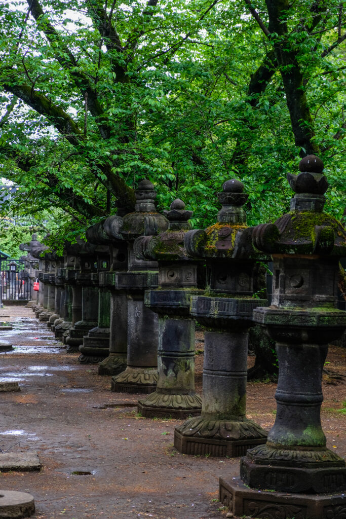 Small shrines on pedestals in Ueno Park.